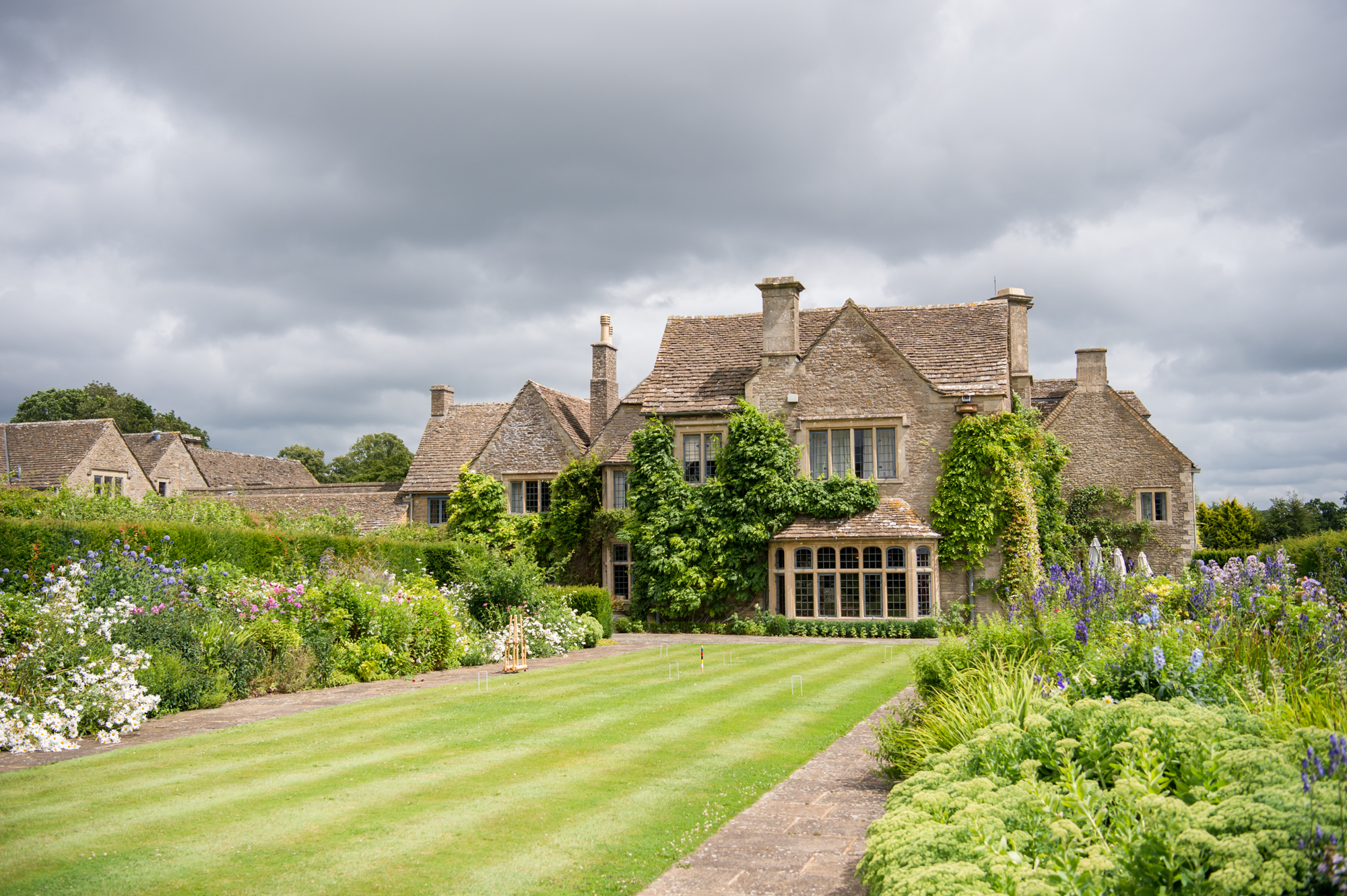 Exterior shot of Whatley Manor with beautiful front gardens